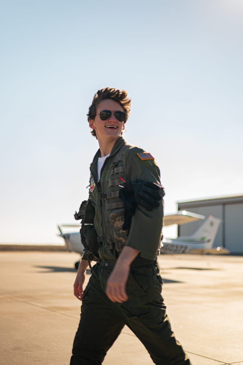 Ben in a flight suit, standing confidently
